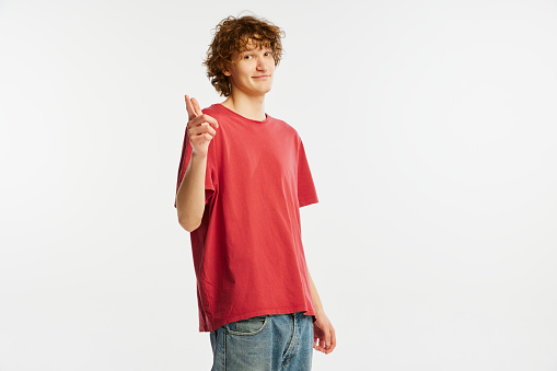 Make your personal choice. Young man with happy facial expression looking at camera isolated over white background. Human rights, emotions, youth, sales, ad. Model, actor wearing red t-shirt