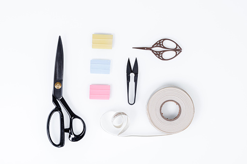 set of ruler, chalk, sticky tape, scissors for sewing on white background close-up