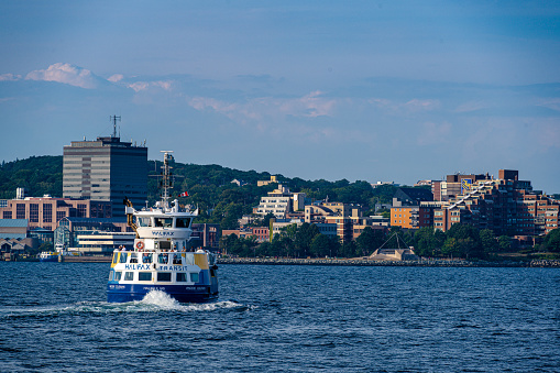 Halifax, Nova Scotia, Canada -- Sept 13, 2022. A photo of a ferry leaving Halifax for Dartmouth on Halifax Harbor.