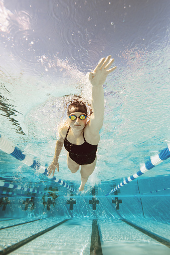 Underwater image of a female swimmer training day at a professional pool