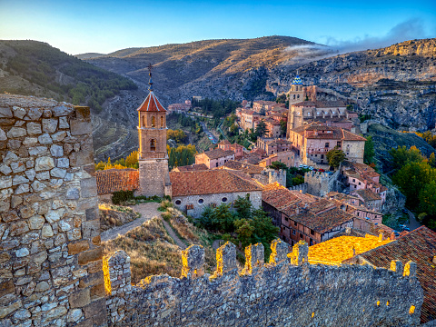 Views of Albarracin at sunset with its walls and the church of Santa Maria y Santiago in the foreground. Teruel, Spain.