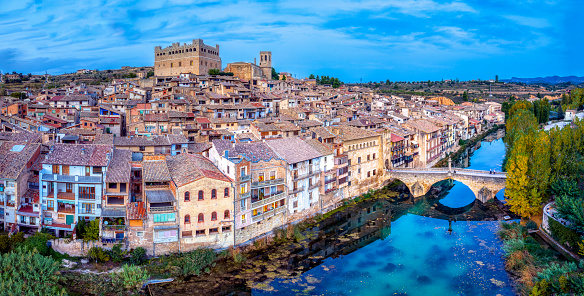 Aerial view of the town of Valderrobres with its bridge and its castle at sunset in Teruel, Spain.