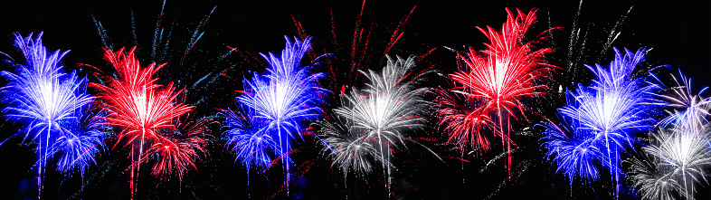 Firework and bokeh lights at night in the colors of the flag from the united states of america (blue, white and red)