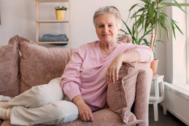 istock Smiling middle aged mature grey haired woman at home 1435593161
