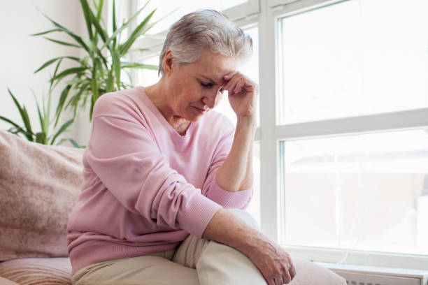 istock middle aged lady looking away sit alone at home feel anxious lonely, sad 1435593832