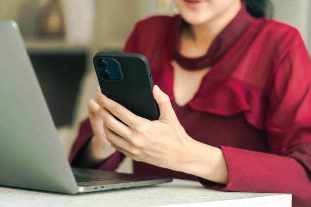 istock Woman marking reservation a hotel ticket on mobile phone application 1435594741