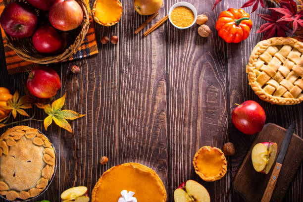 Pieces of traditional American homemade autumn apple and pumpkin pie for Thanksgiving day or Halloween stock photo