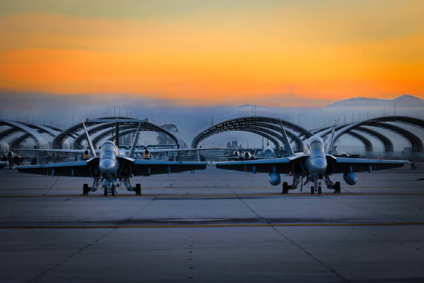 Hornets Miramar, California, USA - September 25, 2022: Two US Marine Corps FA-18 Hornets sit on the tarmac at sunrise for the 2022 Miramar Airshow. miramar air show stock pictures, royalty-free photos & images