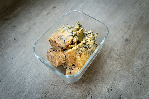 Stilton cheese on a concrete background