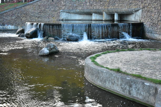 istock Waterfall in a beautiful landscape park next to a reservoir 1435600528