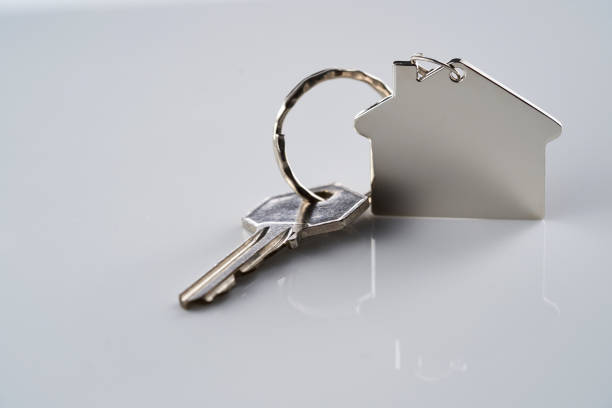 istock house key with house shaped key ring against white background 1435602785