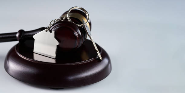 istock Gavel and house key on the table. 1435602786