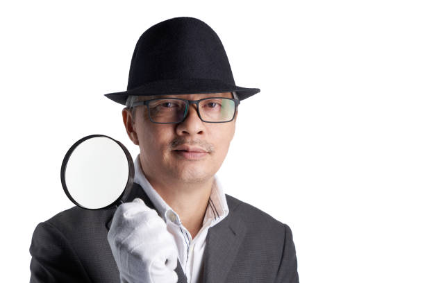 Full length shot of a mature man in a leather trench coat holding an open umbrella solated on white background