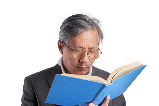 Portrait of attractive cheerful clever grey-haired man hugging book science isolated over bright blue color background.