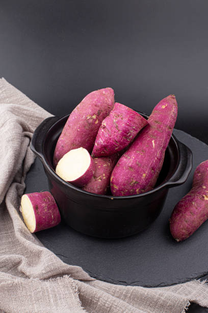 A sweet potato placed on a white background.