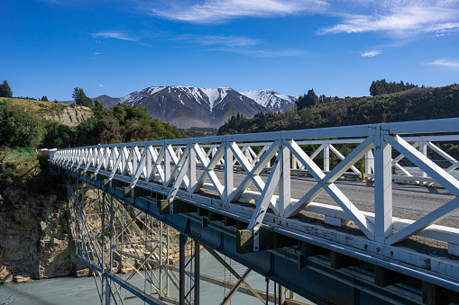 Stunning view of Rakaia Gorge Bridge and Rakaia River in inland Canterbury on New Zealand's South Island. Mountains in the background.