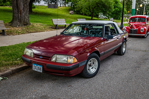 Des Moines, IA - July 01, 2022: High perspective front corner view of a 1989 Ford Mustang LX Convertible at a local car show.