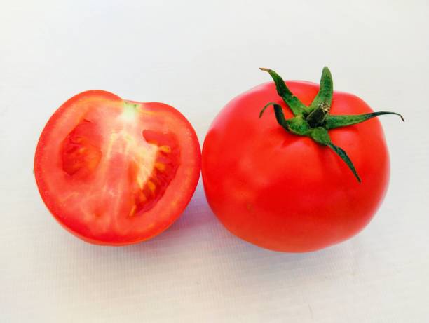 Red cherry tomatoes fruit vine tomato vegetable 
tamaatar tomat timatar pomidor tomate Lycopersicon esculentum solanaceous plum tameto nutritious health beneficial whole and halved closeup view image photo stock photo
