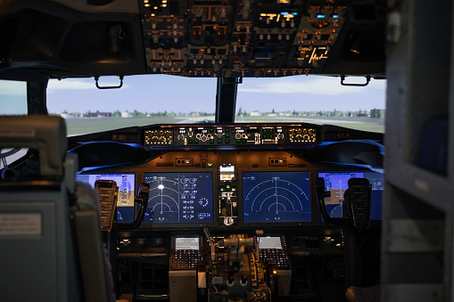 Flight instrumentation in the cockpit of a small plane in the air.  All required instrumentation, plus a GPS and radios are shown in the picture.