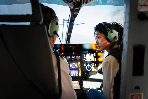 istock Male pilot giving advice to female co-pilot while flying a helicopter 1435607930