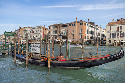 Gondola full of tourists, with Santa Maria della Salute in the background