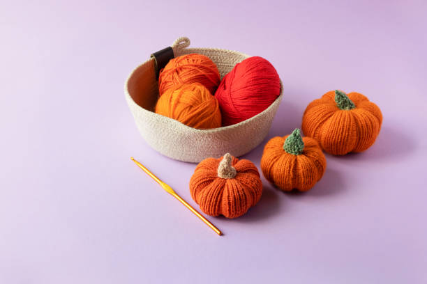 istock Knitted orange pumpkins in a basket 1435610604