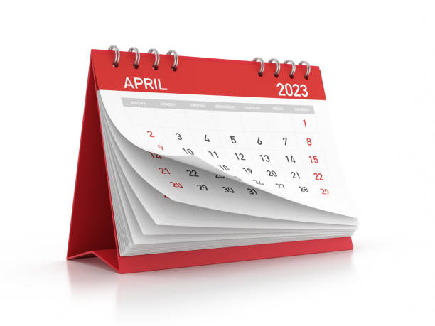 Red 2023 April Monthly Desktop Calendar Isolated on White Background stock photo 2023 April monthly calendar standing on a reflective background. Isolated on white background. Clipping path. april stock pictures, royalty-free photos & images