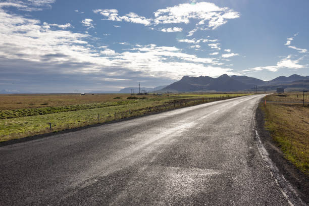 Rural road with sunset light to mountains at Snaefellsnes, Iceland