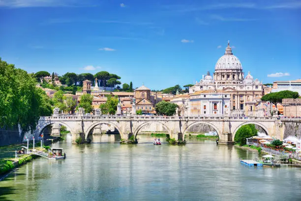 St. Peter's Basilica in Vatican and Tiber river in Rome at sunny day