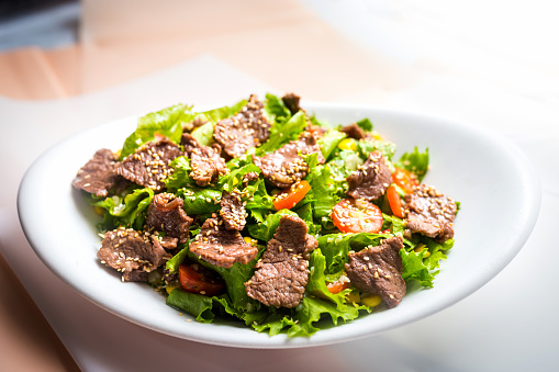 A white bowl of beef salad high resolution stock photo