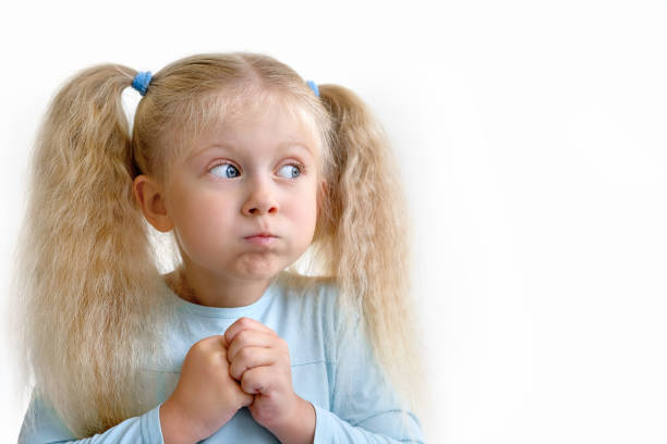 Little blonde girl funny portrait puffed out her cheeks