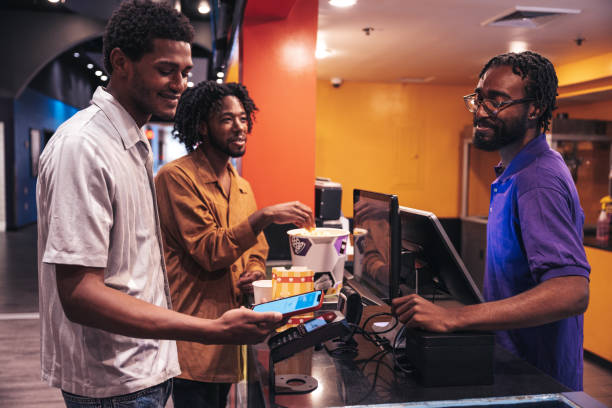istock People buying popcorn and snacks paying with contactless payment through mobile phone app 1435615475