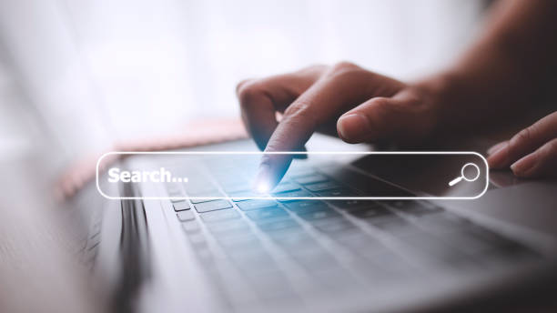 istock People hand using laptop or computor searching for information in internet online society web with search box icon and copyspace. 1435616156