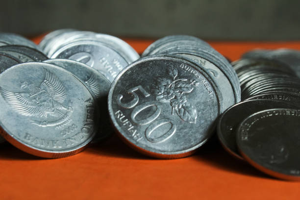 istock a pile of silver Indonesian coins. 1435621681