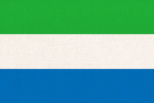 Flag of Sierra Leone. Sierra Leone flag on fabric surface. Fabric Texture. National symbol of Sierra Leone on patterned background. Republic of Sierra Leone