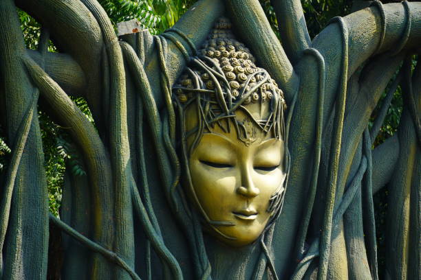A female adult is enjoying sightseeing and admiration golden Buddha statues at Chinese temple in Ipoh, Perak Malaysia.