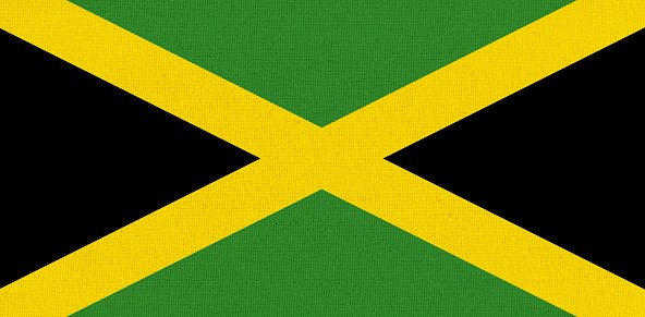 Flag of Jamaica. Jamaican flag on fabric surface. Fabric texture. Jamaica national flag on patterned background