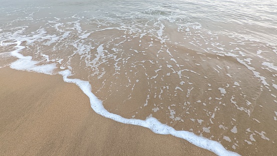 Waves breaking on sandy beach