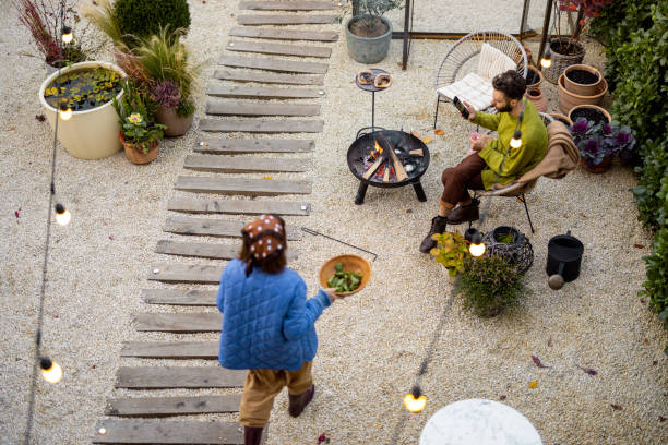 istock Young couple spending dinner time by the fire at backyard 1435628381