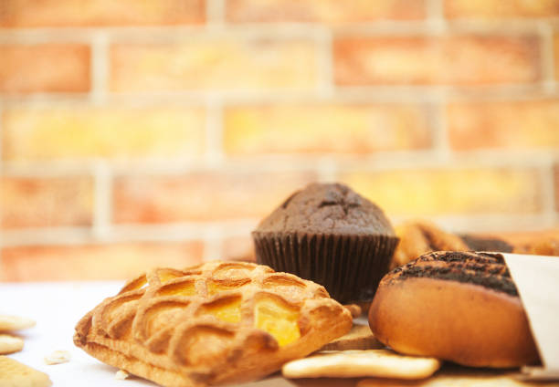 Bright pastries in outdoor cafe with brick wall on a backdrop