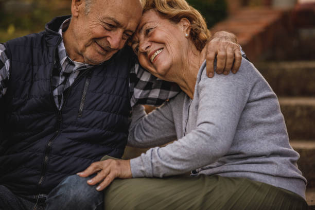 istock Affectionate senior couple sitting embraced on the stairs, having bonding moments 1435629146