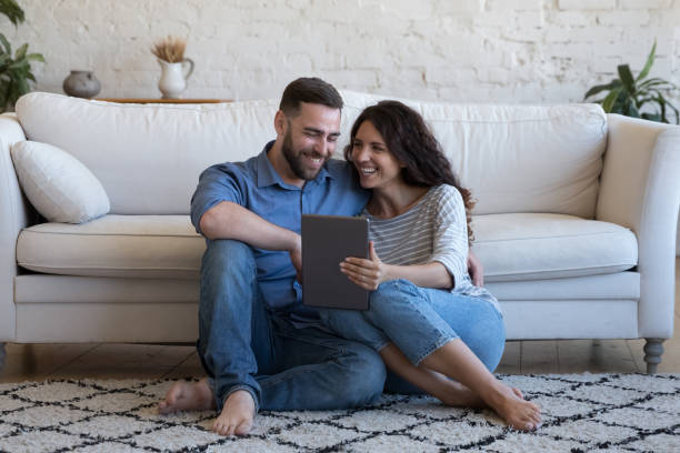 istock Happy couple buying goods on-line using digital tablet 1435631010