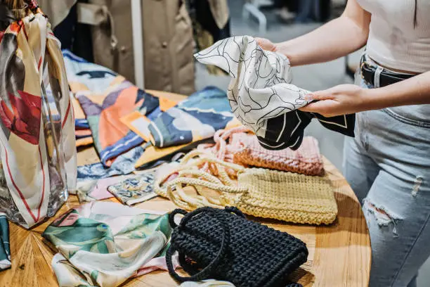 Photo of Sustainable fashion. Modern Latina young woman choosing vintage scarf,