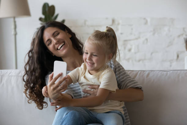istock Mom and kid using modern smartphone at home 1435632709