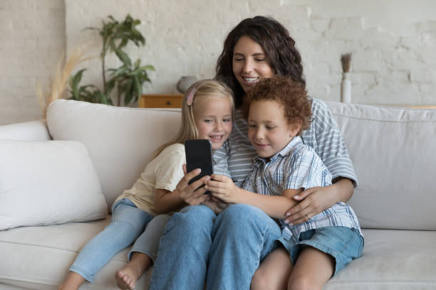 istock Young Hispanic mom her children spend free time on internet 1435632975