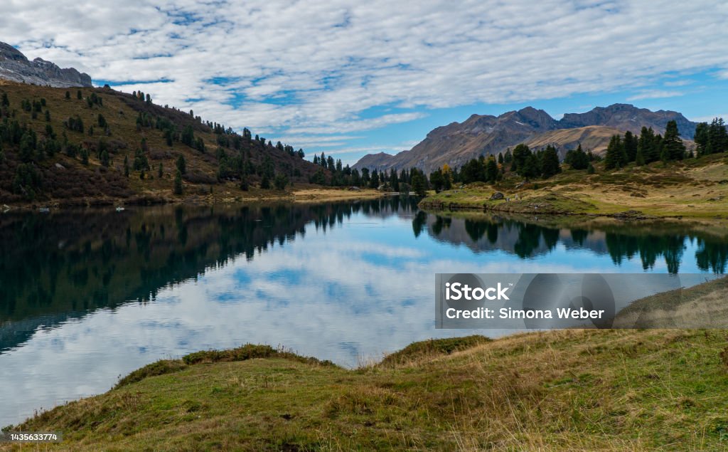 reflection lake Lake in the Swiss alps with clouds reflection and mountains in the background on a nice autumn day Beauty Stock Photo