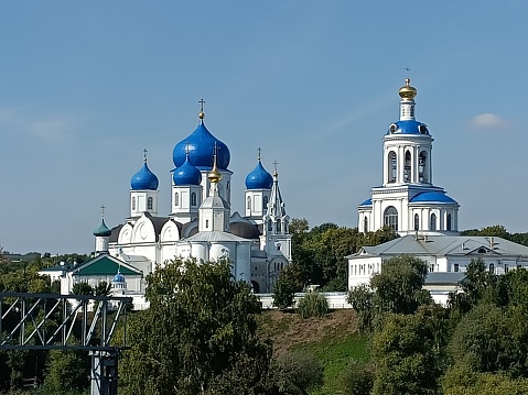 Russian Orthodox church. Old town. Russian culture . Blue summer sky and golden and blue domes. White building facade. Vladimir area. Ancient buildings.