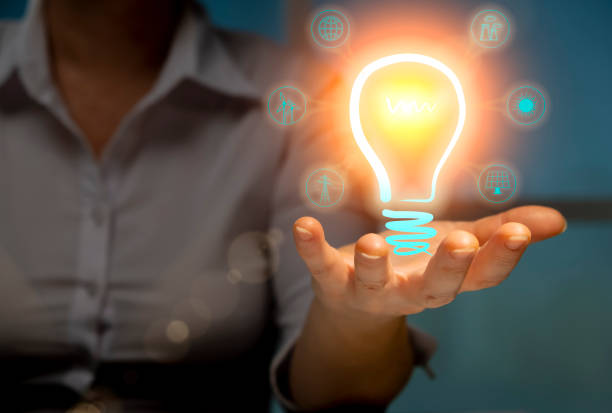 istock Alternative renewable power sources concept, woman engineer holding Illuminated virtual light bulb with green energy icons in hand. 1435636911