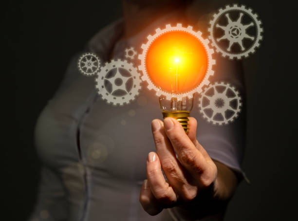 istock New technology development and innovation concept, engineer in hand holding light bulb with gears icons 1435636934