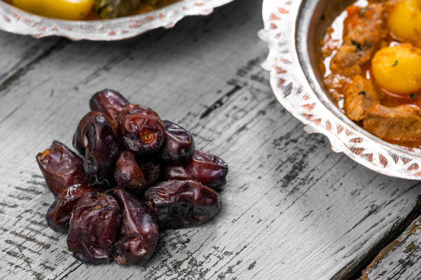 istock Eid Mubarak Traditional Ramadan Iftar dinner. Assorted tasty food in authentic rustic dishes on wooden blue background. Turkish Bosnian food meat kebab, pita, Sarma, klepe, sogan dolma. 1435637947